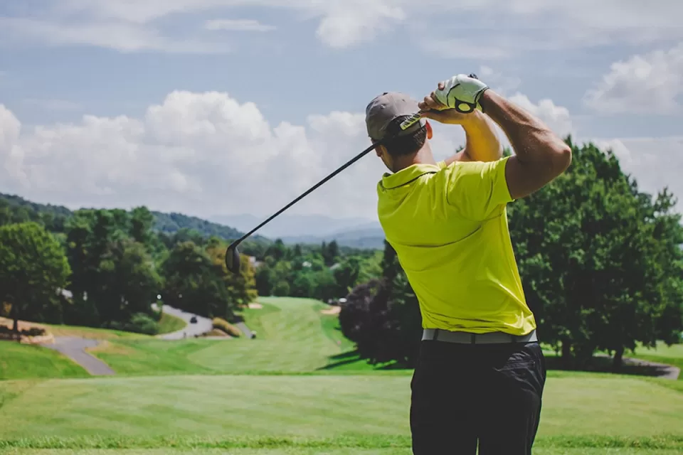 Man golfing on golf course in Watts, Los Angeles, California.